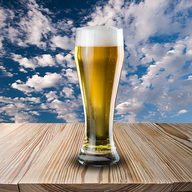istock Glass of cold beer on wood table 450646215