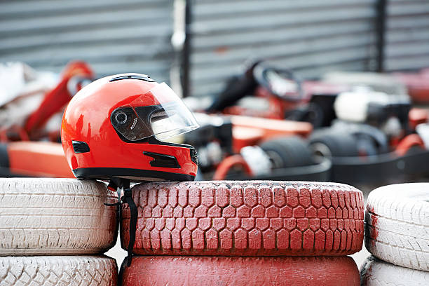 Red helmet with visor is on tires stock photo