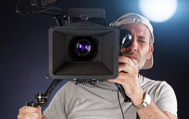 istock cameraman working with a cinema camera on shoulder 450649037