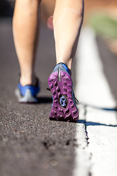 istock Walking or running legs on aspahlt road, adventure and exercisin 450661439
