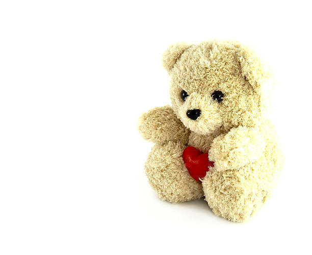 istock teddy bear toy with heart on white background 450663835