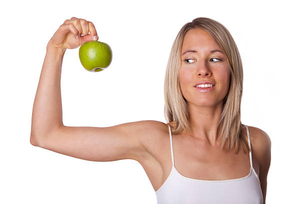 istock fit woman shows apple 450663917