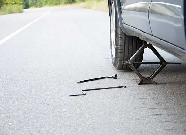 istock Changing car wheel on the road 450667219