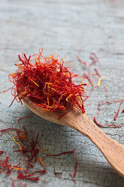 istock Spoon Of Saffron On Old Wooden Surface 450668479