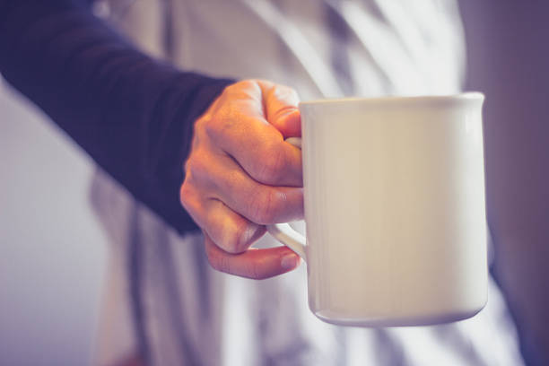 istock Close up on woman's hand holding cup 450668699