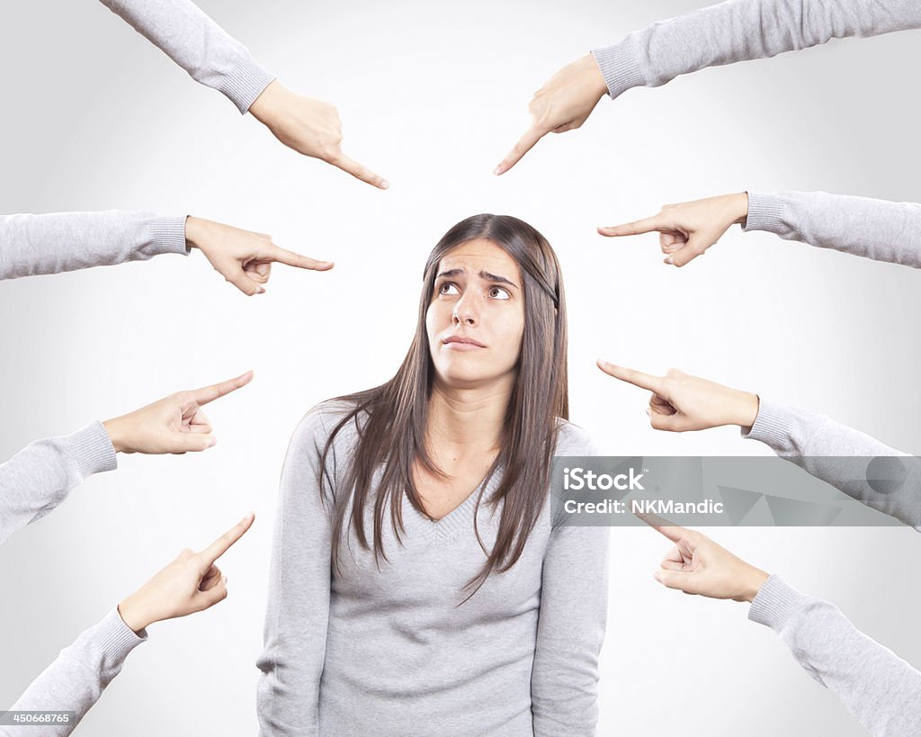 Worried young woman being accused Abuse Stock Photo