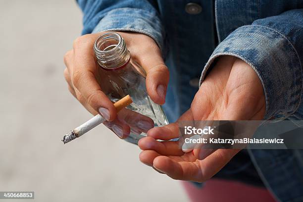 Girl Holding Vodkapills And Cigarettes Stock Photo - Download Image Now - Alcohol - Drink, Drug Abuse, Teenager