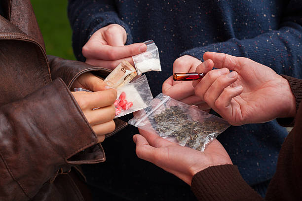 Drug dealer selling drugs Drug dealer selling pills,marijuana and cocaine opium stock pictures, royalty-free photos & images