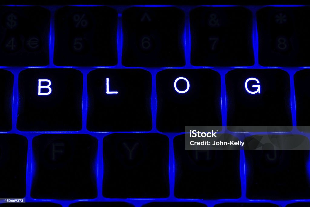 'Blog' Illuminated Keyboard Text in Blue The word 'blog' spelt out on a blue backlit keyboard, letters on the surrounding keys are blank but are still illuminated. Abstract Stock Photo