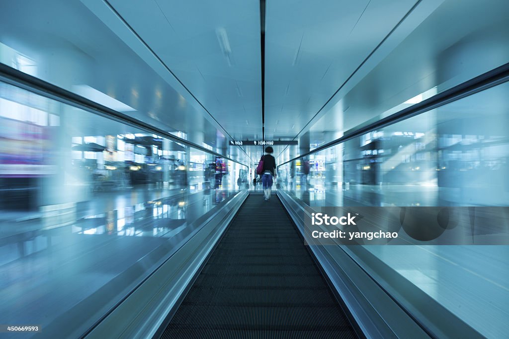 escalator ,interior of airport escalator in the airport with People motion blurred Abstract Stock Photo