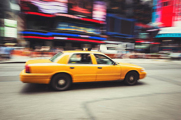 istock taxi panning on times square 450671791