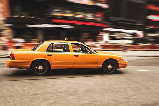 istock taxi panning on times square 450671843