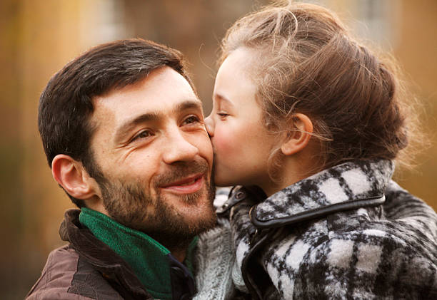 istock Daughter kissing her happy father 450672785