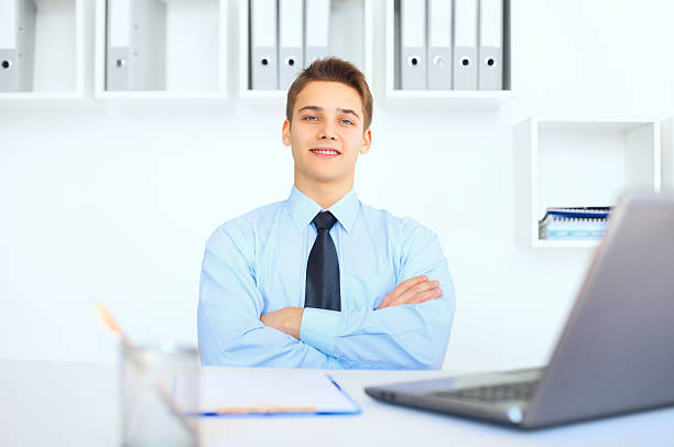 istock Young smiling businessman at his workplace in office 450674787