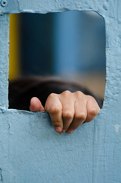 istock Children hand grab through steel door. 450677857