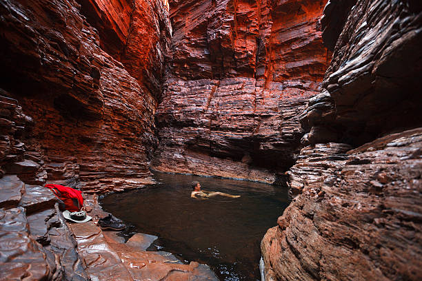 Man swimming water hole deep in gorge stock photo