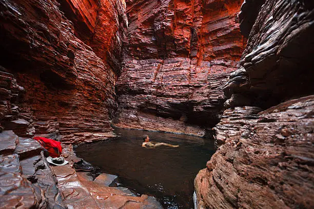 Photo of Man swimming water hole deep in gorge