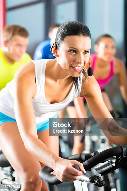 Young People Exercising In The Gym Stock Photo - Download Image Now - Active Lifestyle, Adult, Beautiful People