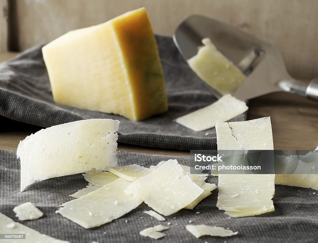 Parmesan cheese slices. Parmesan cheese slices on a rustic fabric. Parmesan Cheese Stock Photo