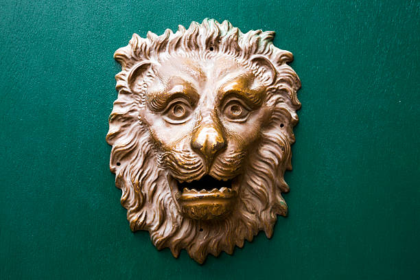 istock Golden lion mailbox against green wood background 450712765