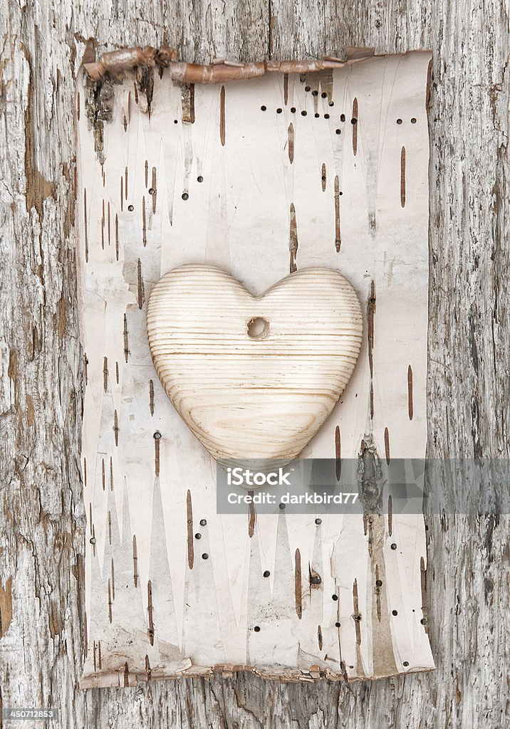 Wooden heart with birch bark on the old wood Wooden heart with birch bark on the old wooden background Abstract Stock Photo