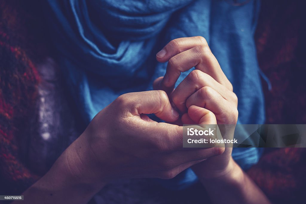 Young woman picking her nails Close up on a young woman's hands as she is picking her nails Anxiety Stock Photo
