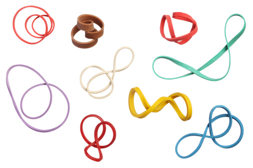 Twisted colorful elastic rubber bands isolated on white background