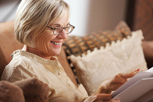istock Senior woman reading book 450727259