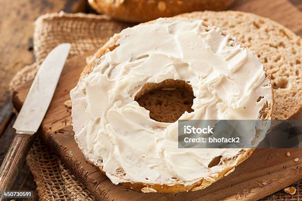 Half Of An Organic Whole Grain Bagel With Cream Cheese Stock Photo - Download Image Now