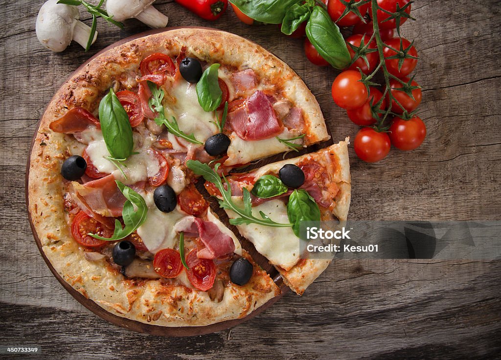 Delicious italian pizza Delicious italian pizza served on wooden table Pizza Stock Photo