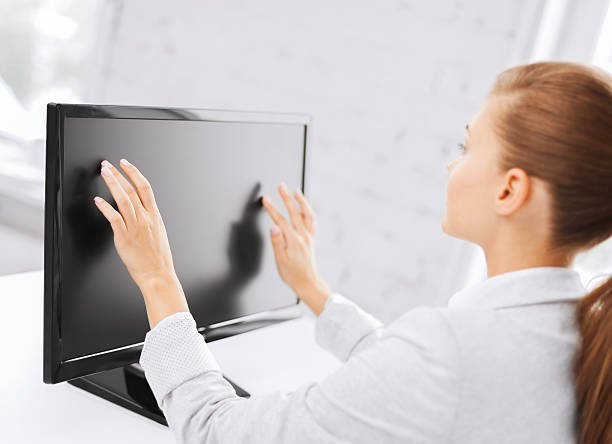 istock smiling businesswoman with touchscreen in office 450736681