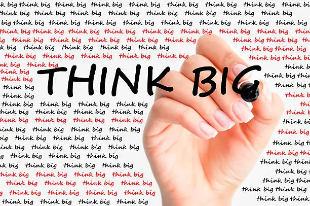Photo of Think big written on a whiteboard