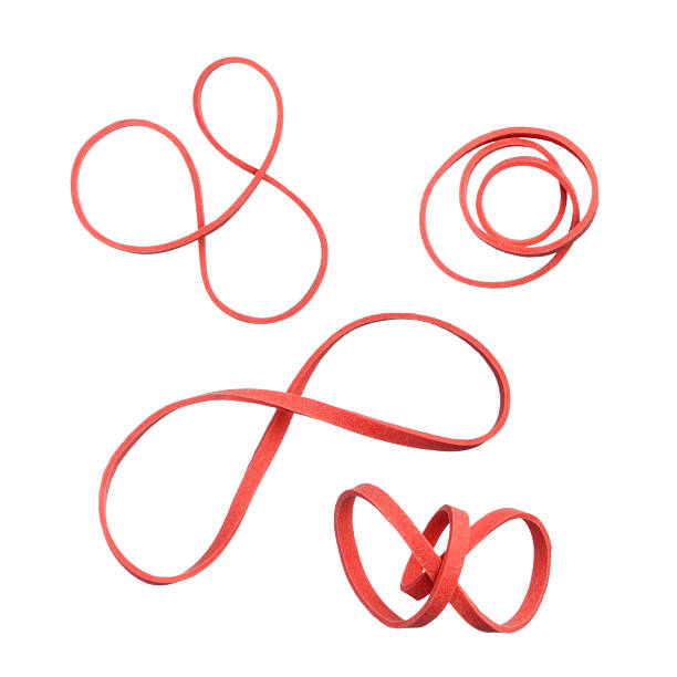 Young adult woman focusing on her fitness routine, stretching a red resistance band with her hands, showcasing dedication to strength training and a healthy lifestyle