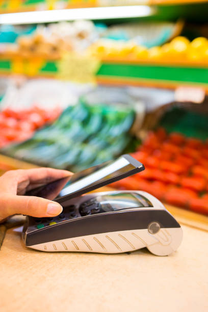 istock Woman paying with nfc technology on mobile phone 450746847