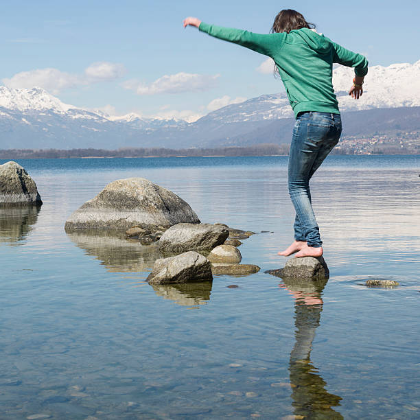 istock Teen balancing on stepping stones 450773577