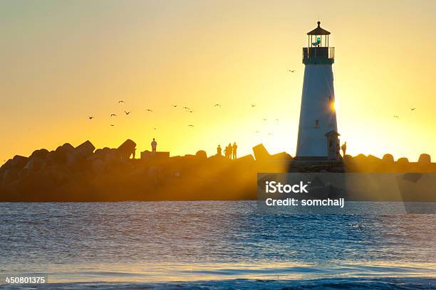 Light House With Sunset In The Background Stock Photo - Download Image Now - Beach, Beacon, Breaking Wave