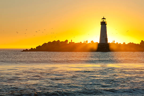 istock Light house with sunset in the background 450801401