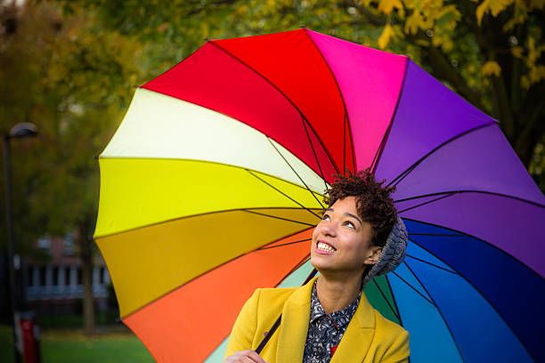 istock Smiling Woman with Colorful Umbrella 450802073