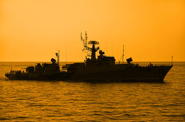 istock silhouette of a warship at sunset 450804203