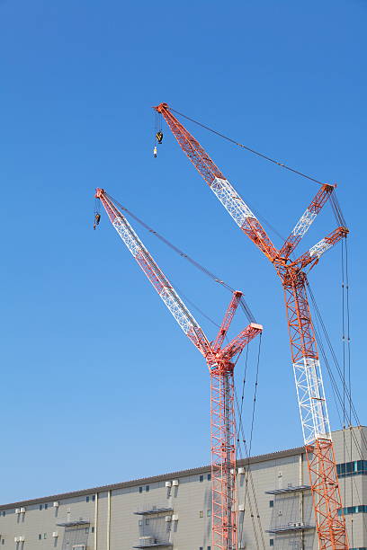 Construction site with crane over a building Construction site with crane over a building construction skyscraper machine industry stock pictures, royalty-free photos & images