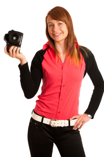 Young woman photographer with camera in her hand