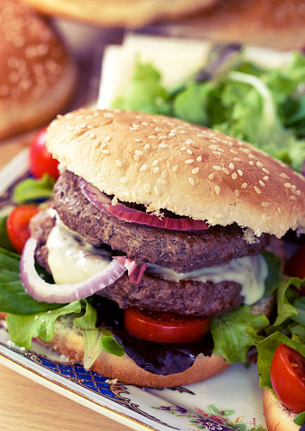 istock Double hamburger with cheese, salad and onion 450806453