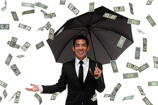 istock Raining money on a businessman 450806655