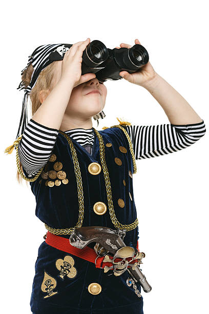 маленькая девочка пиратский глядя через бинокль - little girls pre adolescent child standing isolated стоковые фото и изображения