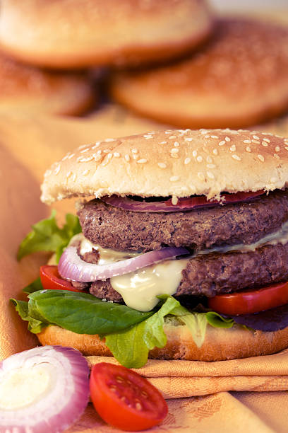 istock Double hamburger with cheese, salad and onion 450811649
