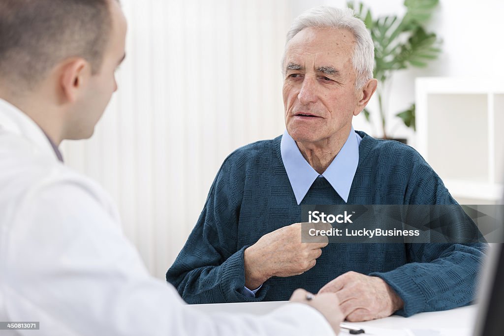 Doctor and an Elderly Patient Senior man sits with his doctor and he complained of chest pain 70-79 Years Stock Photo
