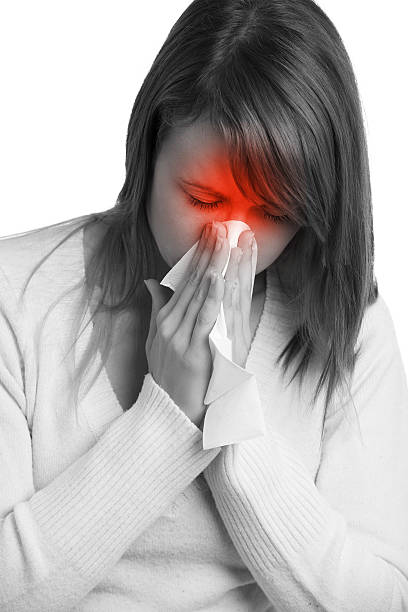 istock Woman with flu blowing nose in a tissue 450815081