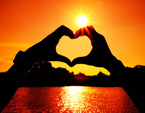 heart shape made with man and woman hands