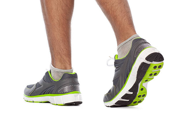 Cropped shot of a woman tying the shoelaces of her sports shoe