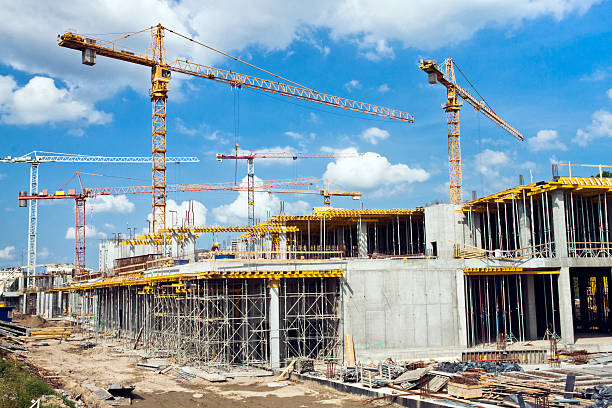 new industry construction building and cranes under construction against blue sky hoisting photos stock pictures, royalty-free photos & images